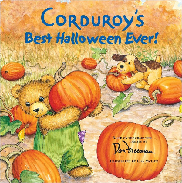 Corduroy the bear holding a pumpkin