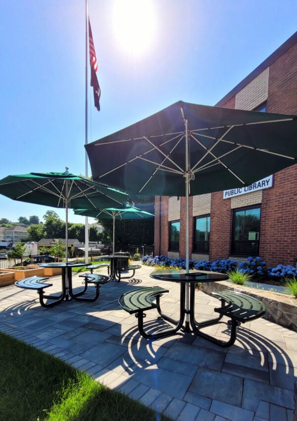 Tables with umbrellas in the West Harrison garden.